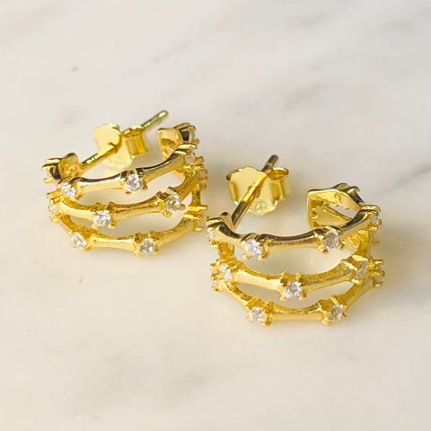 Gold triple hoop cubic zirconia earrings.